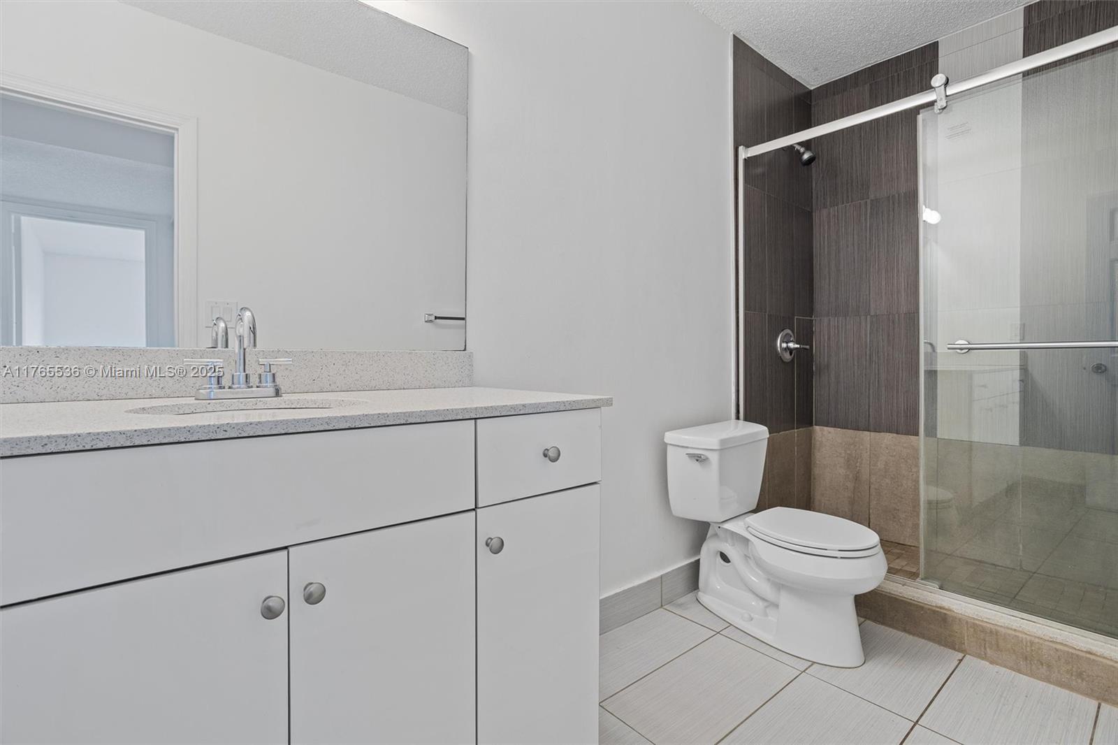 4920 Northwest 79th Avenue, Unit 309 Doral, FL 33166 - Photo 18 of 33 a bathroom with a sink toilet and shower