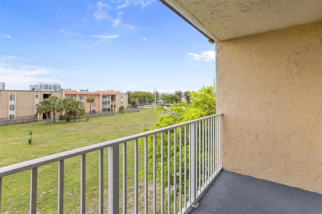 a view of balcony and yard
