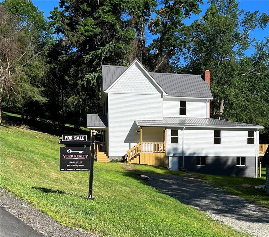 945 McElree Road Washington, PA 15301 - Photo 2 of 16 a view of a white house next to a yard with big trees