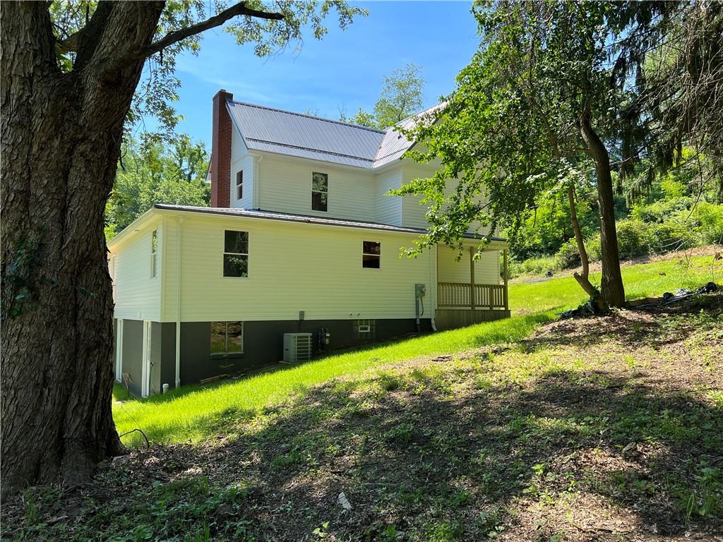 945 McElree Road Washington, PA 15301 - Photo 4 of 16 a front view of a house with a yard