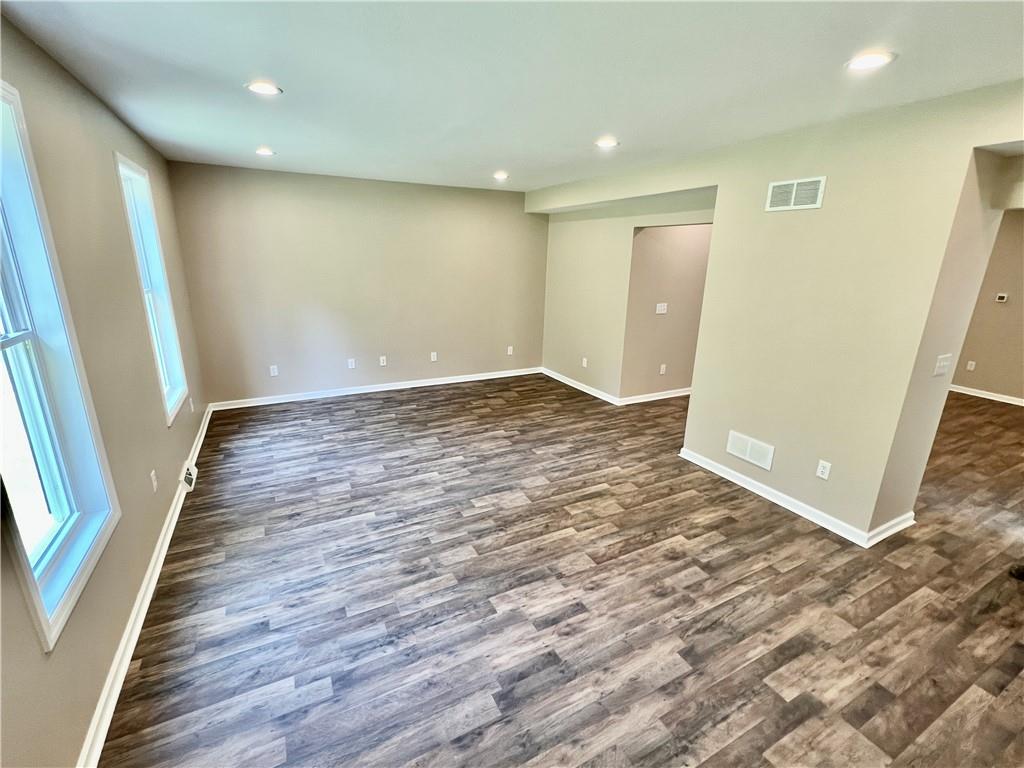 945 McElree Road Washington, PA 15301 - Photo 6 of 16 an empty room with wooden floor and entrance