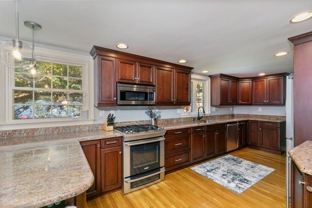 31 Robert Street Wakefield, MA 01880 - Photo 12 of 41 a kitchen with stainless steel appliances granite countertop a stove top oven a sink dishwasher and microwave oven