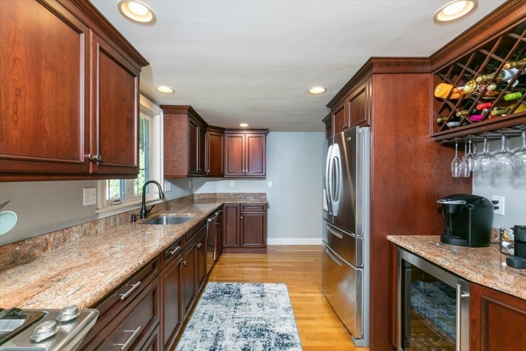 31 Robert Street Wakefield, MA 01880 - Photo 13 of 41 a kitchen with stainless steel appliances granite countertop a refrigerator a stove top oven and sink