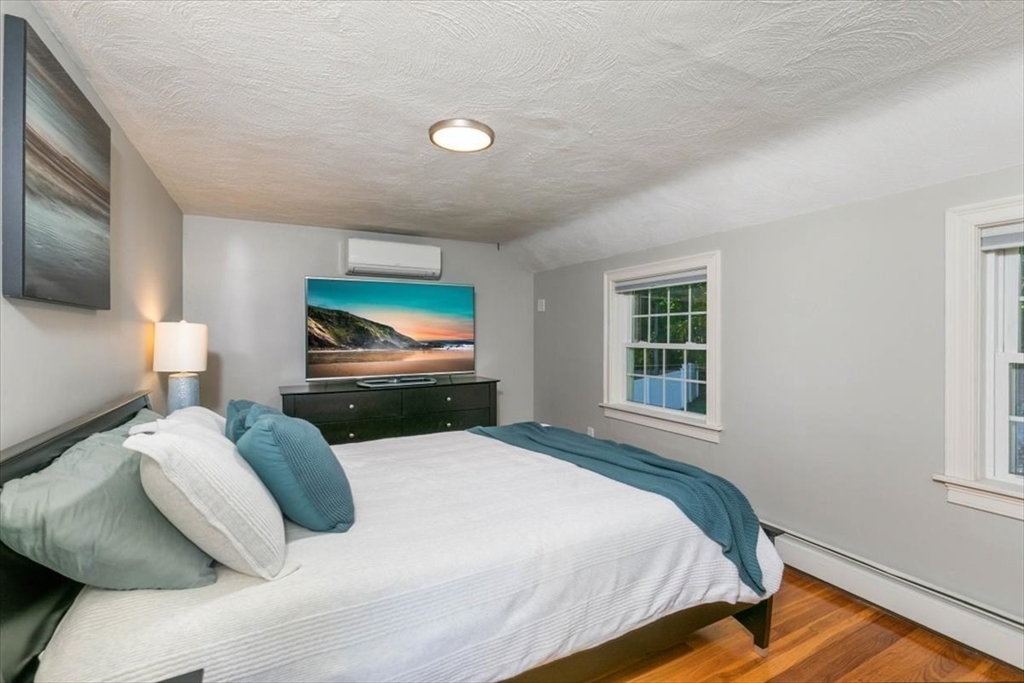 31 Robert Street Wakefield, MA 01880 - Photo 24 of 41 a bedroom with a bed and a flat screen tv