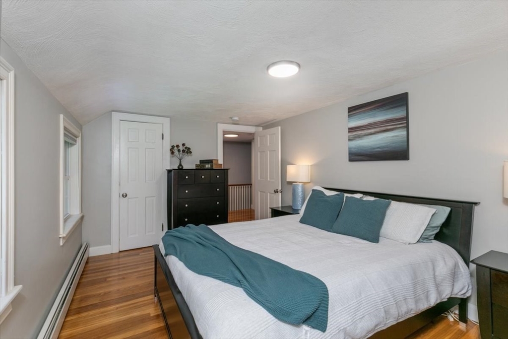 31 Robert Street Wakefield, MA 01880 - Photo 25 of 41 a bedroom with a bed and wooden floor