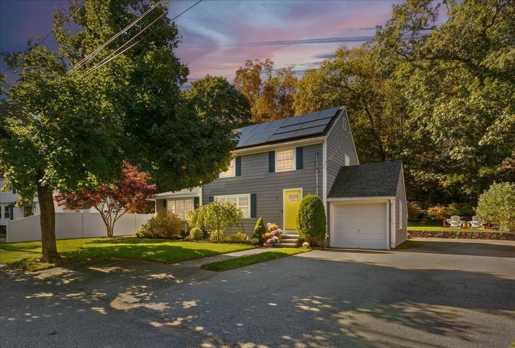 31 Robert Street Wakefield, MA 01880 - Photo 4 of 41 a front view of a house with a yard and garage