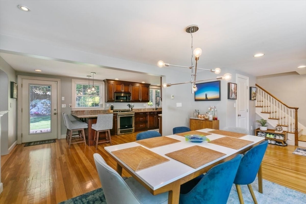 31 Robert Street Wakefield, MA 01880 - Photo 10 of 41 a dining room with a table chairs and a kitchen view