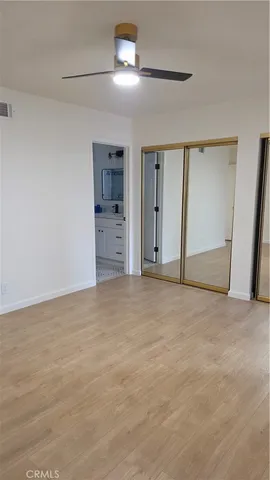 a view of empty room with kitchen and window