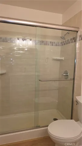 a bathroom with a shower a toilet and a shower