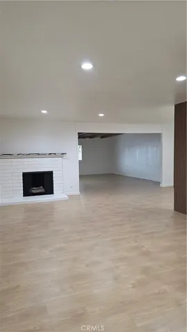a view of an empty room with a fireplace