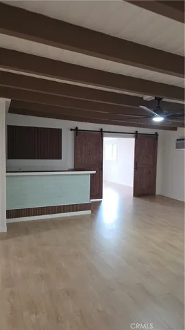 a view of a livingroom with an empty space and a fireplace