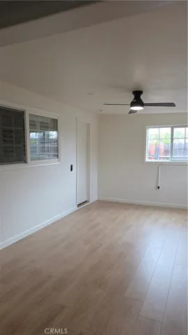 an empty room with a empty space and windows