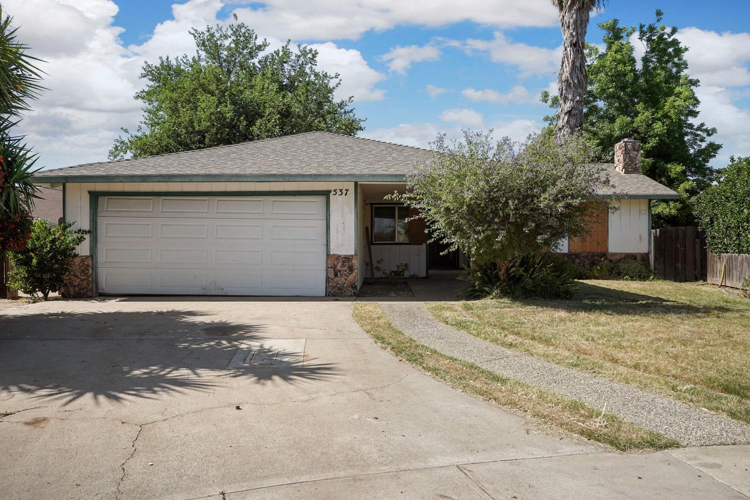 537 Dawn Court Ripon, CA 95366 - Photo 1 of 1 a front view of a house with a yard and garage