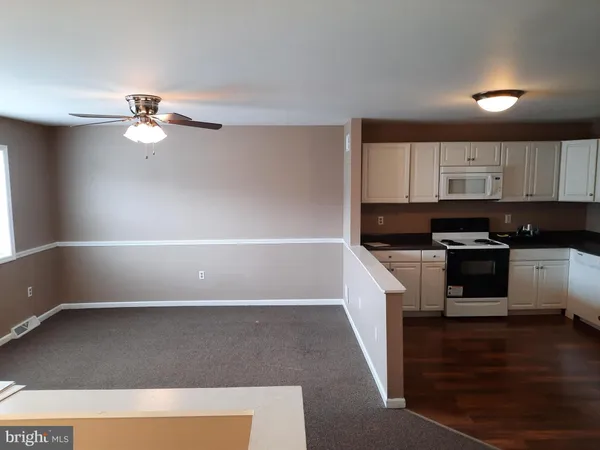 a kitchen with a cabinets and white appliances