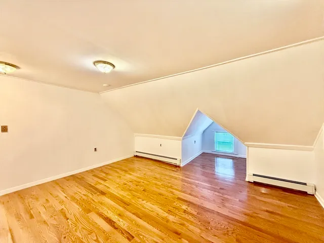 a view of hallway with wooden floor