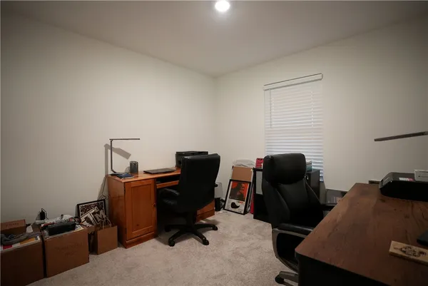 a view of a workspace with furniture and a window