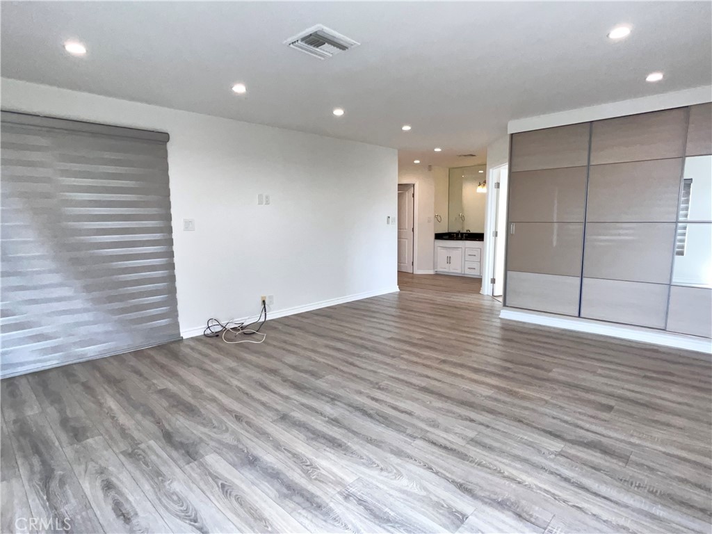 881 Harrington Road Glendale, CA 91207 - Photo 22 of 35 an empty room with wooden floor and natural light