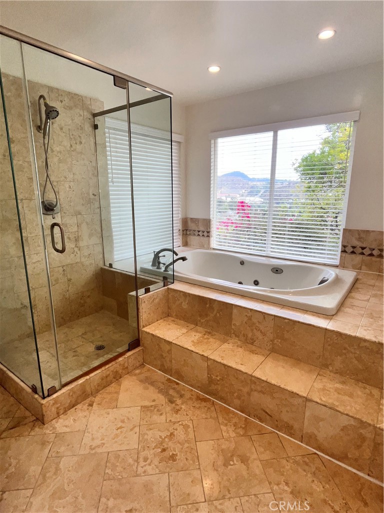 881 Harrington Road Glendale, CA 91207 - Photo 24 of 35 a bathroom with a large tub a shower and view