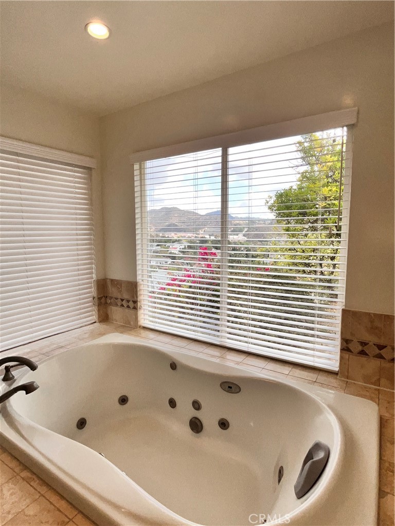 881 Harrington Road Glendale, CA 91207 - Photo 25 of 35 a bathroom with a bathtub and next to a window