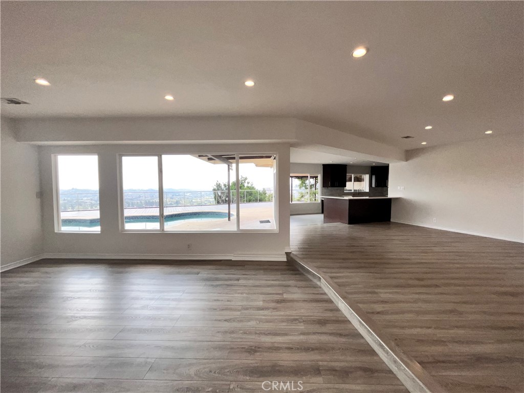881 Harrington Road Glendale, CA 91207 - Photo 5 of 35 an empty room with wooden floor and windows