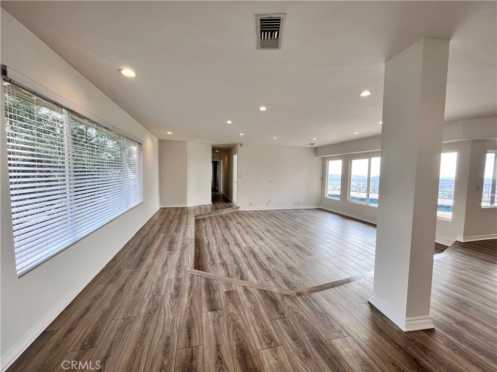881 Harrington Road Glendale, CA 91207 - Photo 7 of 35 a view of an empty room with wooden floor and a window