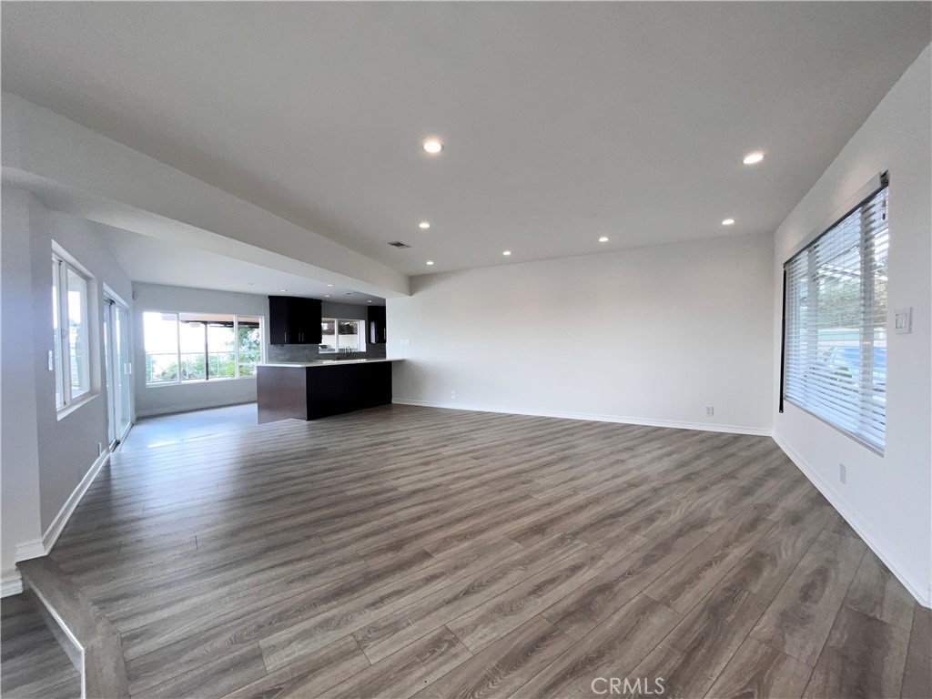 881 Harrington Road Glendale, CA 91207 - Photo 9 of 35 a view of empty room with wooden floor and fireplace