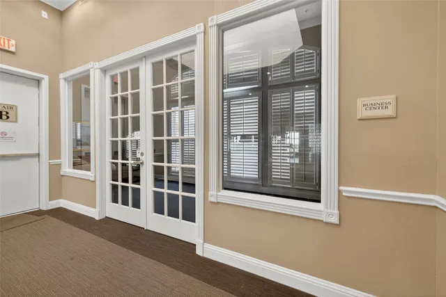 a living room with lots of furniture and a large window
