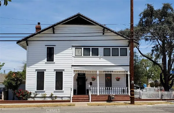 a view of a white house with large windows