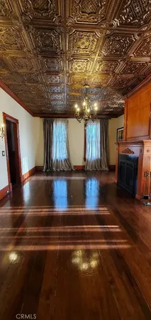 a view of water heater room with wooden floor