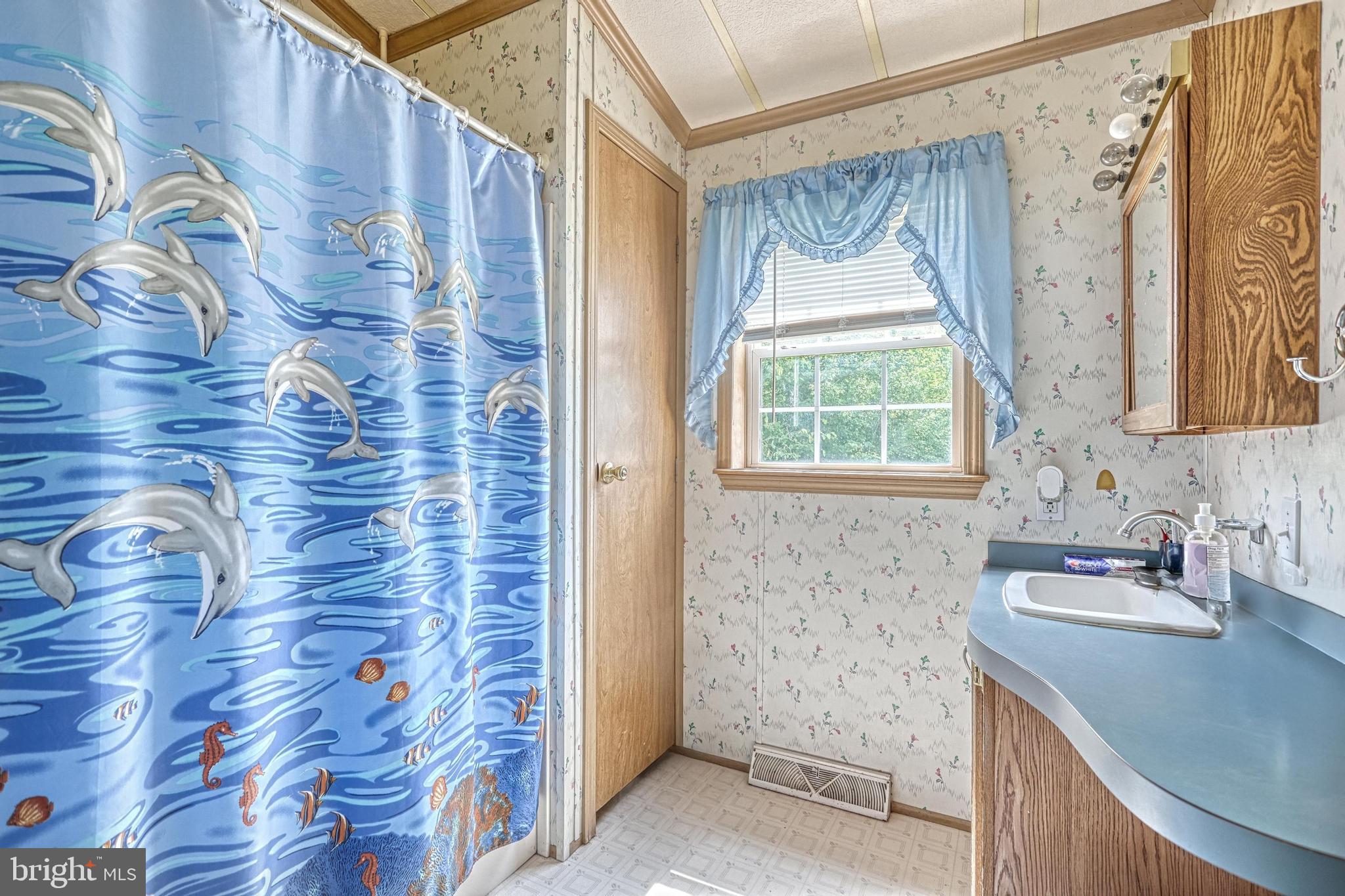 13859 Ebaugh Road Stewartstown, PA 17363 - Photo 18 of 61 a bathroom with a granite countertop sink a mirror and shower