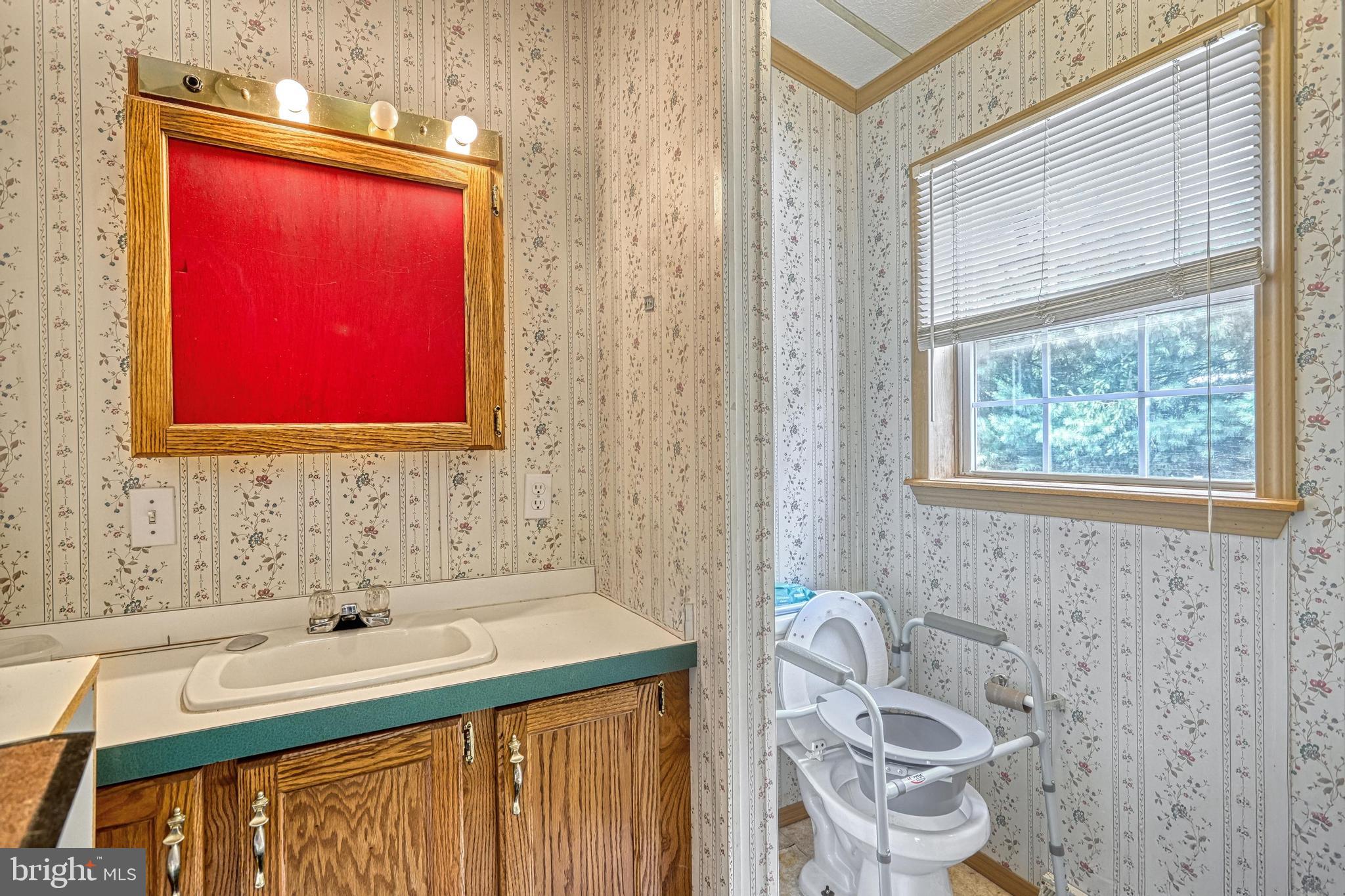 13859 Ebaugh Road Stewartstown, PA 17363 - Photo 23 of 61 a bathroom with a sink a chair and next to a window