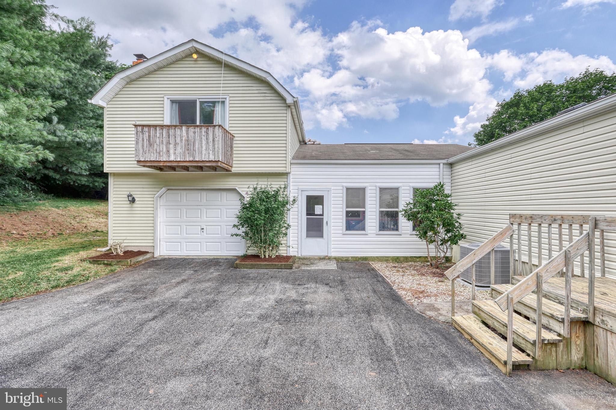 13859 Ebaugh Road Stewartstown, PA 17363 - Photo 3 of 61 a front view of a house with a yard and garage