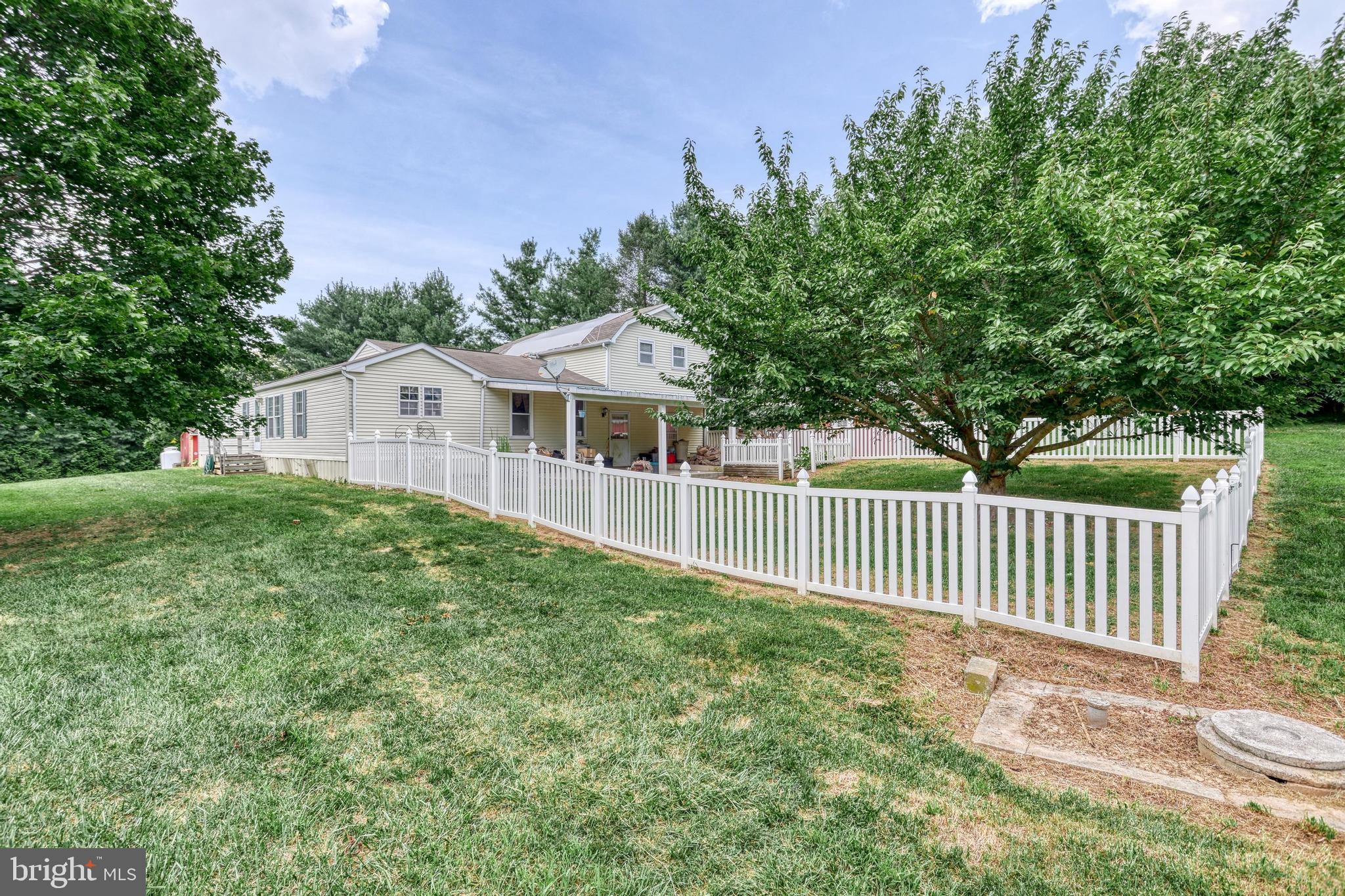 13859 Ebaugh Road Stewartstown, PA 17363 - Photo 31 of 61 a view of a house with a small yard and a garden