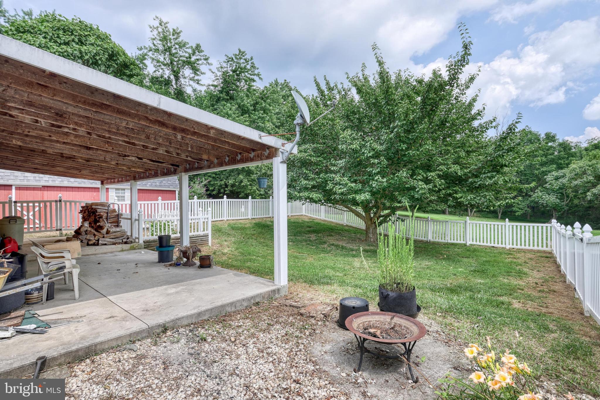 13859 Ebaugh Road Stewartstown, PA 17363 - Photo 32 of 61 a backyard of a house with yard and outdoor seating