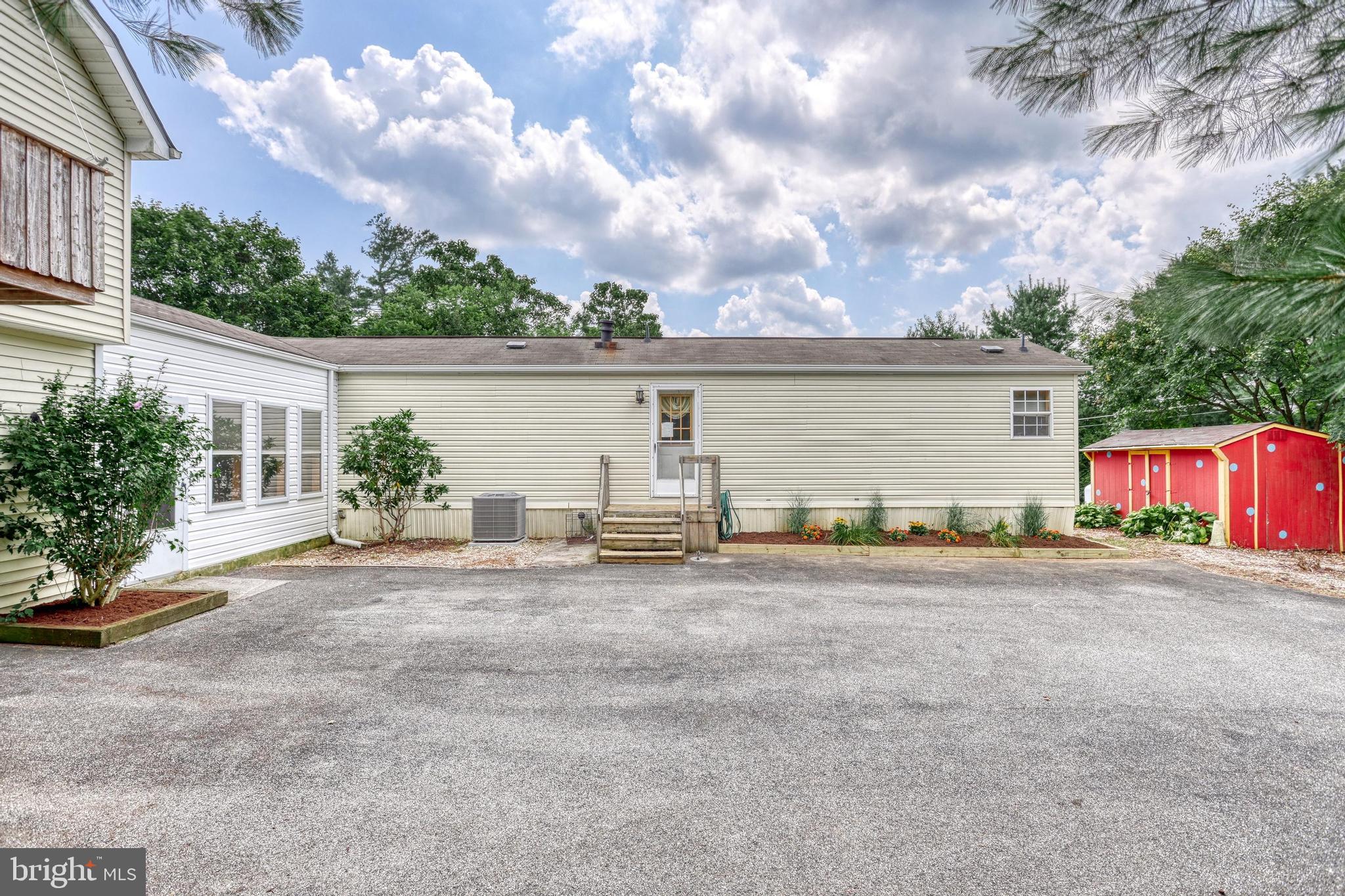 13859 Ebaugh Road Stewartstown, PA 17363 - Photo 4 of 61 a view of a house with backyard and a garage