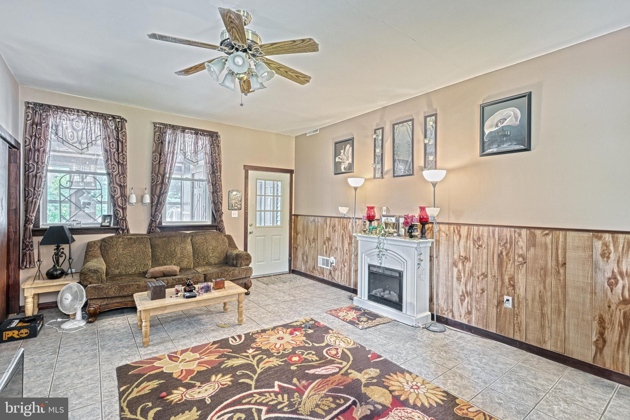 13859 Ebaugh Road Stewartstown, PA 17363 - Photo 5 of 61 a living room with furniture fireplace and a window