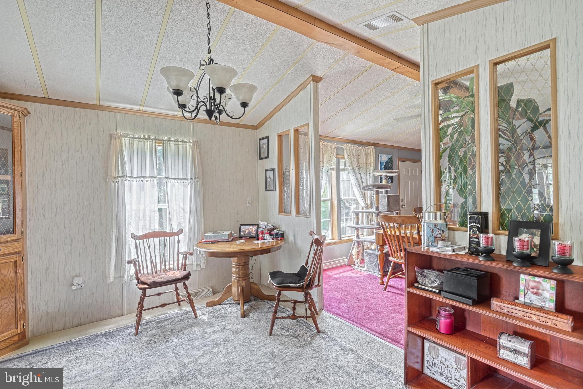 13859 Ebaugh Road Stewartstown, PA 17363 - Photo 8 of 61 a living room with furniture a window and a chandelier
