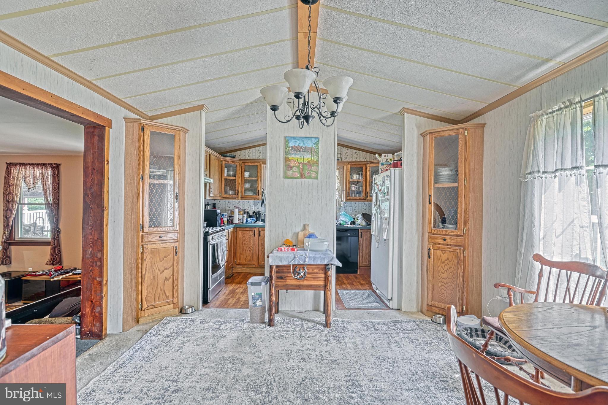 13859 Ebaugh Road Stewartstown, PA 17363 - Photo 9 of 61 a living room with furniture a chandelier and a dining table