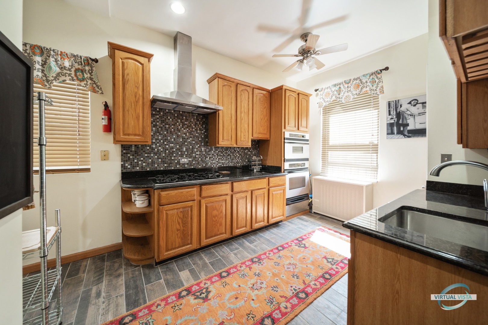 1529 East Marquette Road Chicago, IL 60637 - Photo 8 of 37 a kitchen with stainless steel appliances granite countertop a sink stove and wooden cabinets