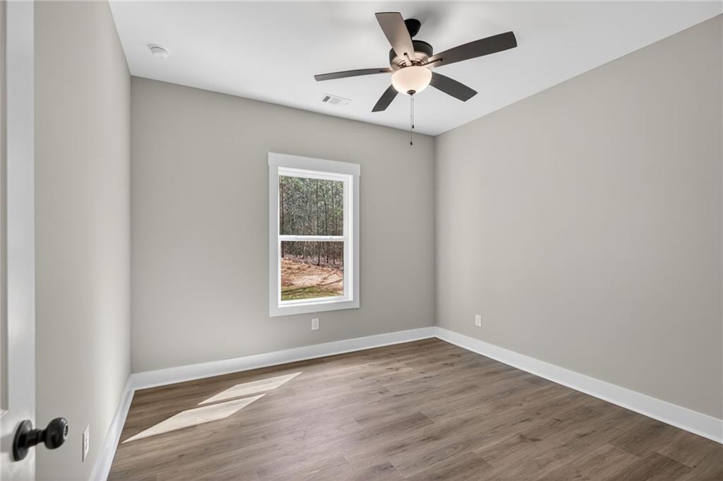 423 Relay Road Silver Creek, GA 30173 - Photo 32 of 48 an empty room with a window and a fan