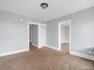 an empty room with closet area