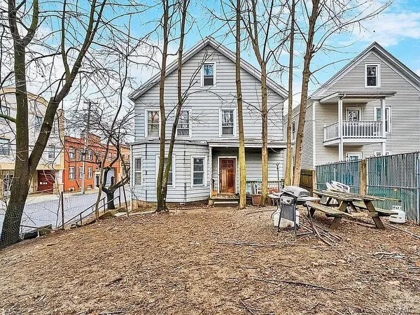 a backyard of a house with outdoor seating