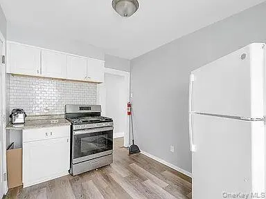 a kitchen with a stove a refrigerator and a sink