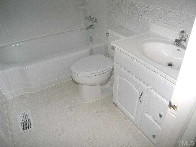 2705 Newbold Street Raleigh, NC 27603 - Photo 17 of 18 a bathroom with a sink and toilet