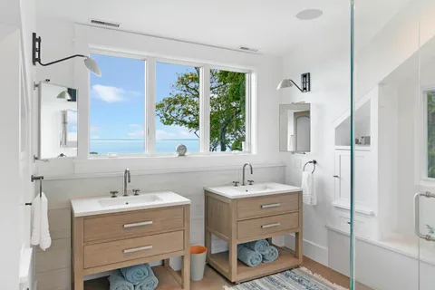 a bathroom with a double vanity sink mirror and