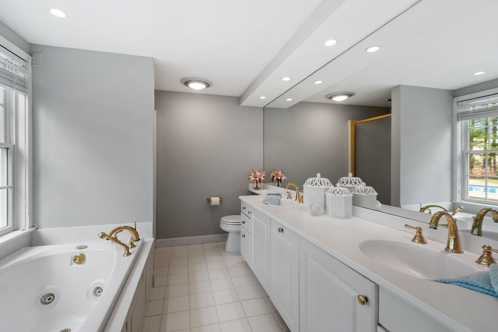 17 Enfield Drive Andover, MA 01810 - Photo 14 of 37 a bathroom with a tub 2 sink and mirror