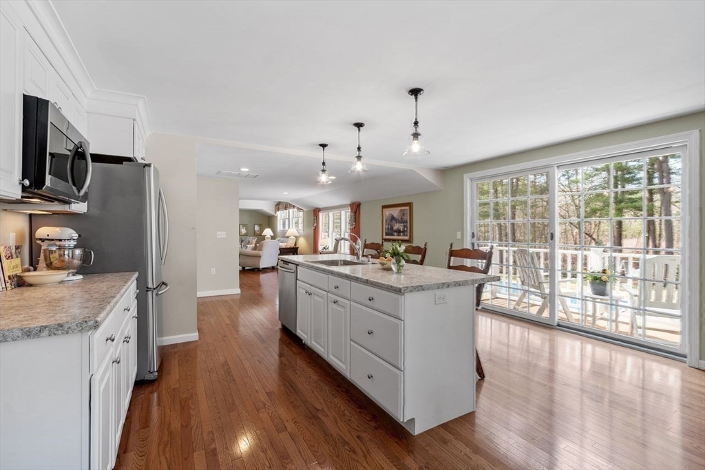 17 Enfield Drive Andover, MA 01810 - Photo 21 of 37 a large white kitchen with a large window a sink and stainless steel appliances