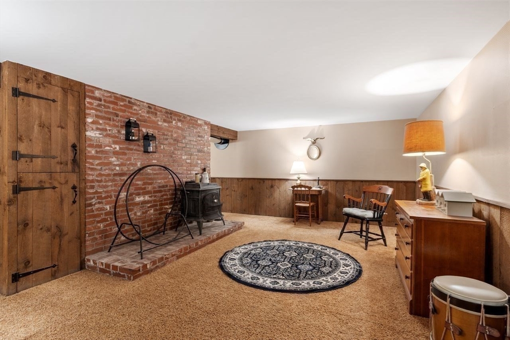 17 Enfield Drive Andover, MA 01810 - Photo 29 of 37 a living room with furniture a piano and a fireplace