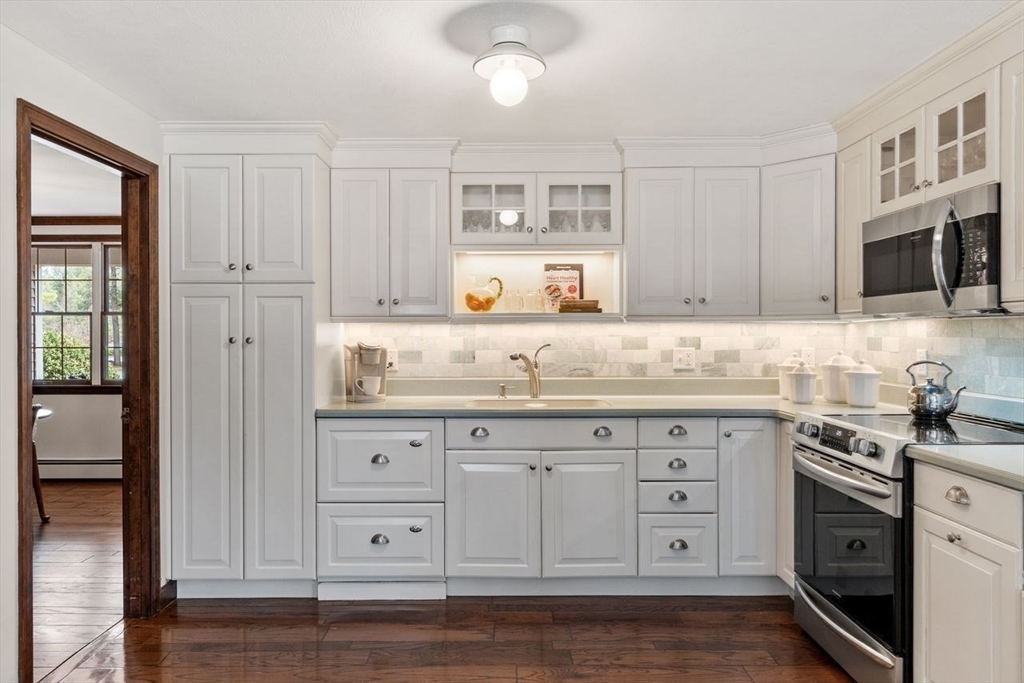 17 Enfield Drive Andover, MA 01810 - Photo 5 of 37 a kitchen with granite countertop white cabinets and stainless steel appliances