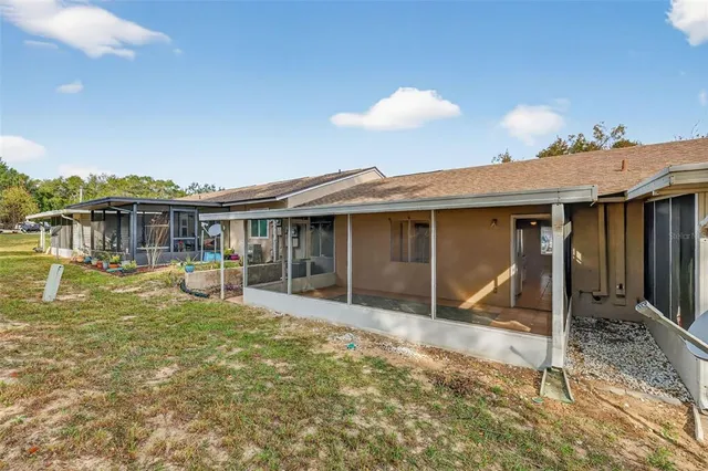 a view of a house with a yard balcony and sitting area